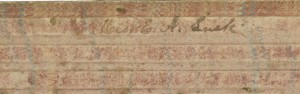 Picture shows the upper edge of a writing board or tablet over a white background. The tablet is made of a brown cardboard-like material with a faded pink and blue marbled pattern and has raised, tactile, evenly spaced bars on its surface. In the center of the first bar, handwritten script reads “Mrs. E. A. Lusk.” [End of description]