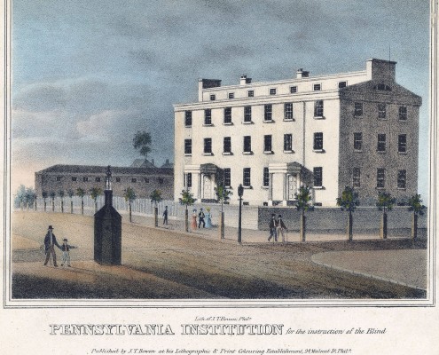 Picture shows a four-story rectangular building with many rectangular windows. The building includes two front entrances with porticos. The structure is white, and its front is lit by sunlight. Pedestrians – eight total with six men, two women and one boy – walk on the sidewalk in front of and across from the building. Small trees evenly line the sidewalk in front and to the left of the building. A dark-colored watchman’s guardhouse, shaped like a chimney, stands across the street from the building. A man with a cane, and a boy, holding his hand, walk past the guardhouse. The boy appears to be gesturing in the direction of the guardhouse and the building. Text printed below the images reads: “Lith. Of J. T. Bowen, Phila. Pennsylvania Institution for the Instruction of the Blind. Published by J.T. Bowen at his Lithographic & Print Colouring Establishment, 94, Walnut St Philada. Entered according to act of Congress in the year 1840 by J. T. Bowen in the Clerk’s Office of the Dt. Ct. for the En. Dt. of Pa.[End of description]