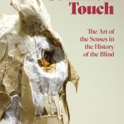 Picture shows the catalog cover illustrated with a profile, close-up of Teresa Jaynes’s Gift #1, a brown and white paper owl. Text in red letters is printed to the upper right of the image of the owl. Text reads: Common Touch [next line] The Arts of the Senses in the History of the Blind. [end of description]
